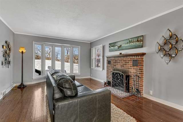 living room with a fireplace, ornamental molding, a textured ceiling, wood finished floors, and baseboards