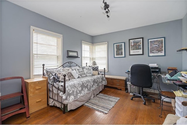 bedroom featuring dark wood finished floors