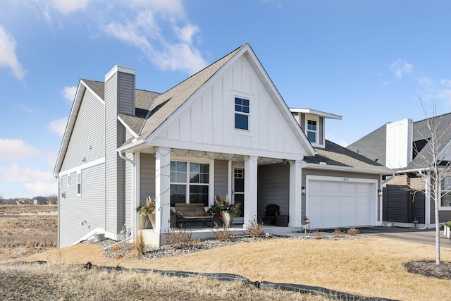 view of front of home with a garage, roof with shingles, a porch, and board and batten siding