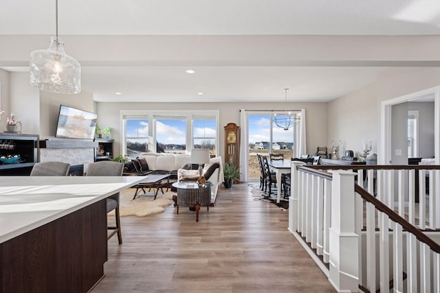 kitchen featuring light wood-style floors, recessed lighting, decorative light fixtures, and a notable chandelier