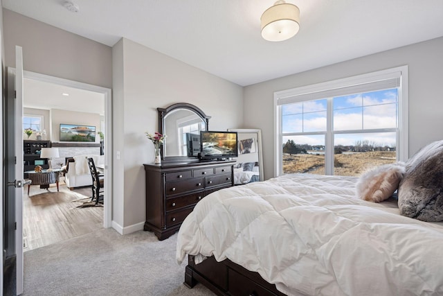 bedroom with light colored carpet and baseboards