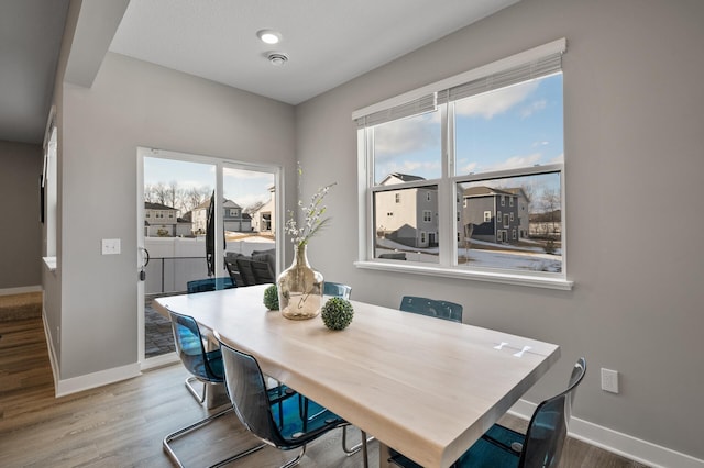 dining room featuring baseboards and wood finished floors