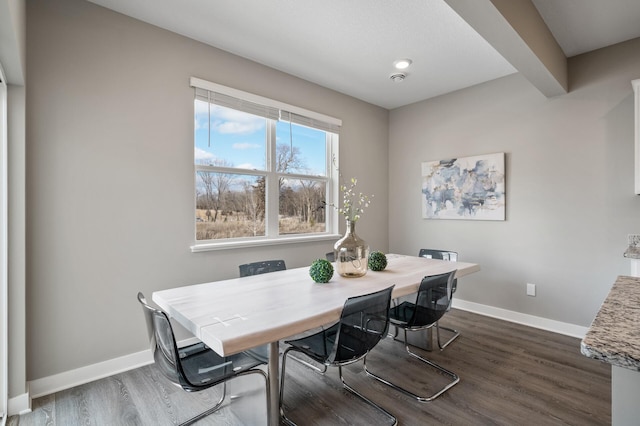 dining area featuring dark wood finished floors and baseboards