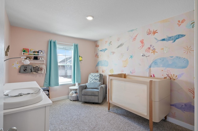 bedroom featuring baseboards, carpet floors, a textured ceiling, and wallpapered walls