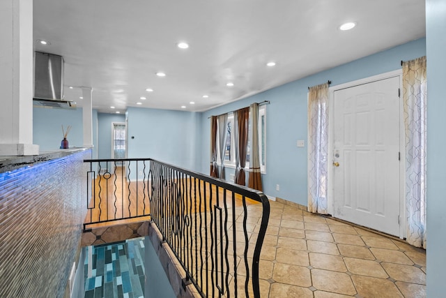 corridor featuring an upstairs landing, light tile patterned floors, and recessed lighting