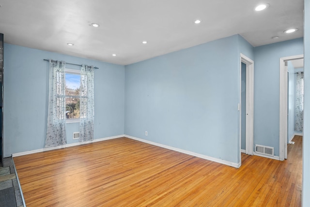 spare room featuring recessed lighting, visible vents, and light wood finished floors