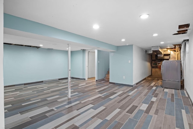 finished below grade area with baseboards, stairway, and recessed lighting