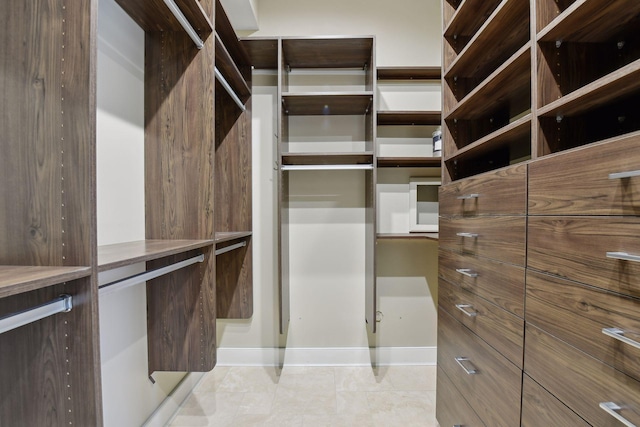 walk in closet featuring light tile patterned floors