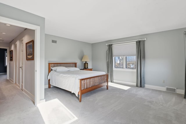 bedroom with carpet floors, visible vents, and baseboards