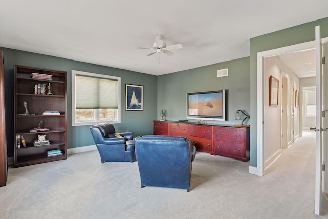 office with light carpet, baseboards, visible vents, and ceiling fan