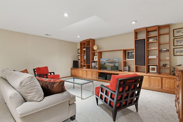 living area featuring recessed lighting, light colored carpet, and visible vents