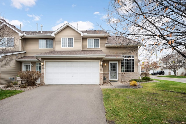 view of front of house with an attached garage, brick siding, aphalt driveway, and a front yard