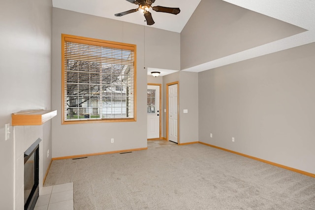 unfurnished living room with a fireplace with flush hearth, baseboards, ceiling fan, and light colored carpet