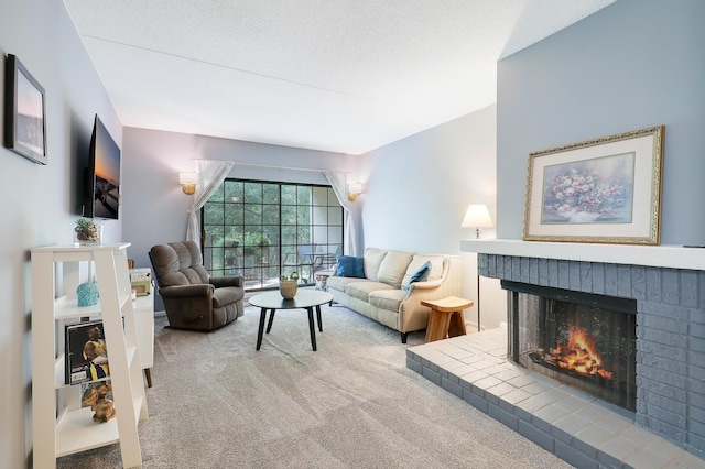 carpeted living area featuring a brick fireplace and a textured ceiling