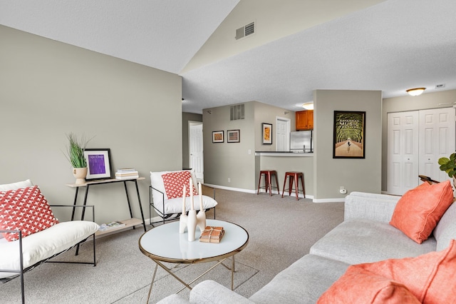 carpeted living area featuring lofted ceiling, baseboards, visible vents, and a textured ceiling