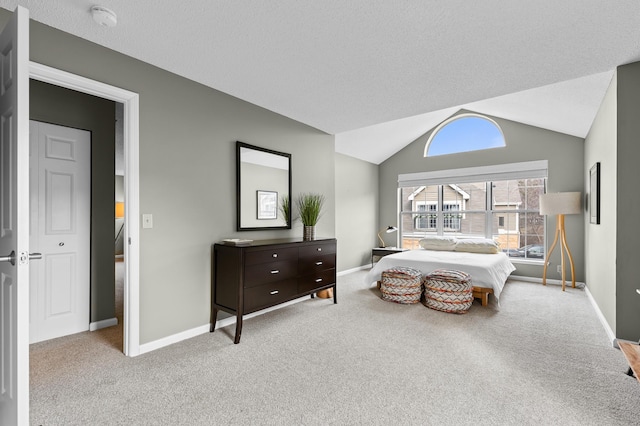 carpeted bedroom with lofted ceiling, baseboards, and a textured ceiling