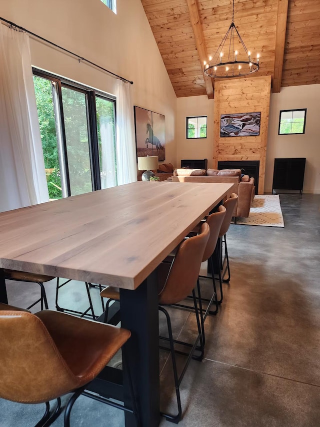 dining space featuring high vaulted ceiling, wooden ceiling, a fireplace, and finished concrete flooring