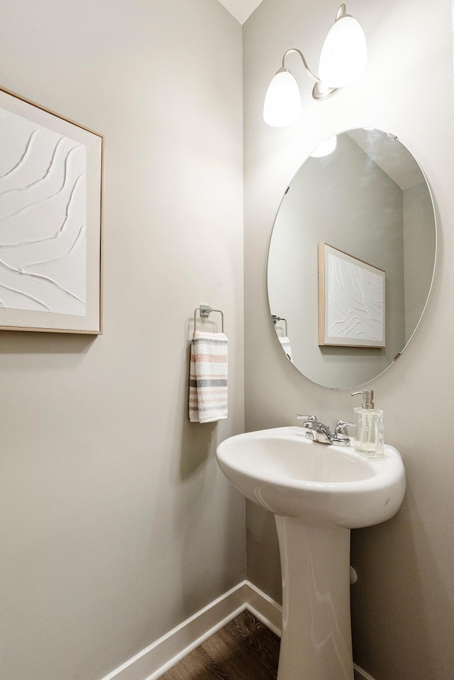 bathroom with baseboards and wood finished floors