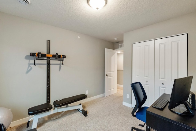 office area featuring baseboards, visible vents, and light colored carpet