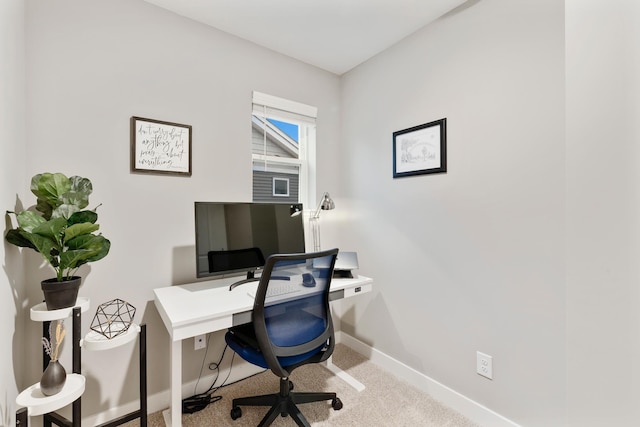 carpeted office space with baseboards