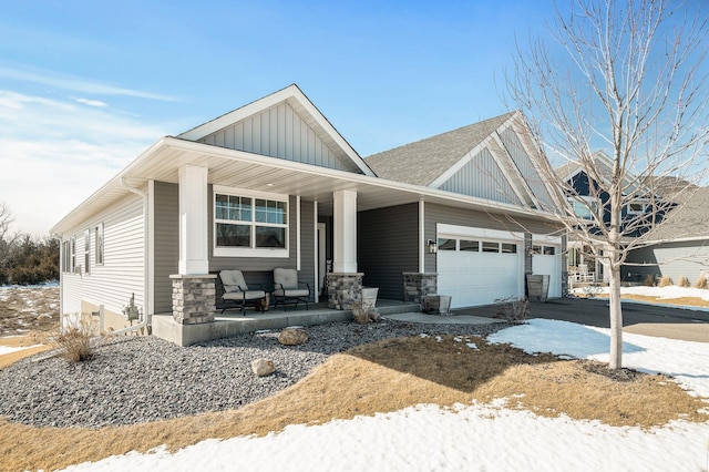 craftsman-style home featuring roof with shingles, covered porch, an attached garage, board and batten siding, and driveway