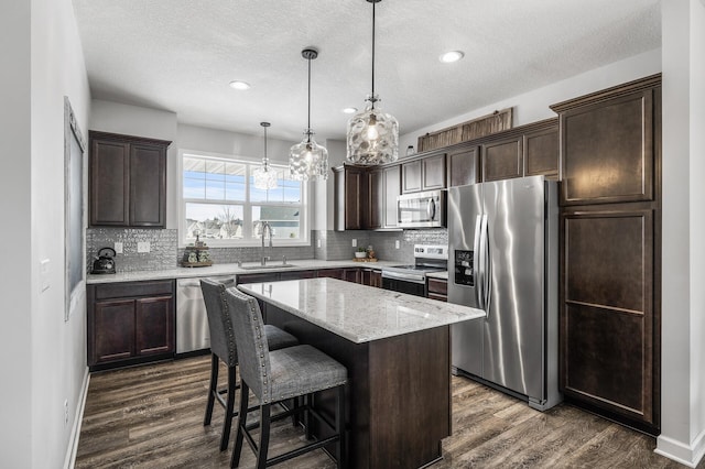 kitchen featuring dark brown cabinets, appliances with stainless steel finishes, and a sink