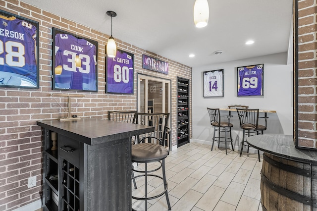 bar with brick wall, baseboards, and recessed lighting