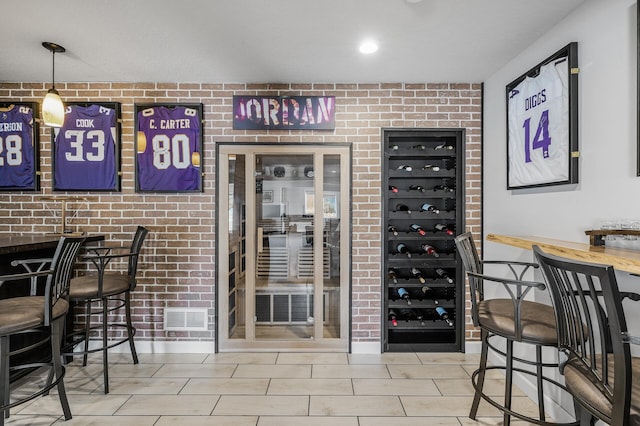 wine area with brick wall and visible vents