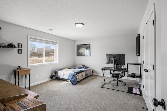 bedroom with carpet flooring, a textured ceiling, and baseboards