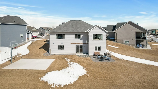 rear view of house with a patio area, a shingled roof, and a yard