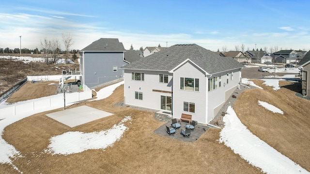 rear view of property with a patio area, a fenced backyard, and roof with shingles