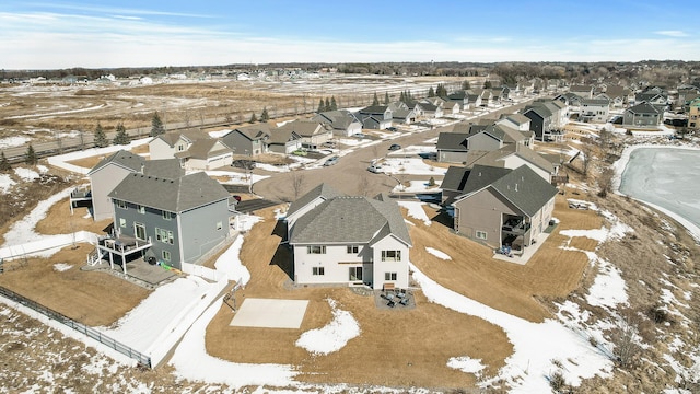 snowy aerial view featuring a residential view