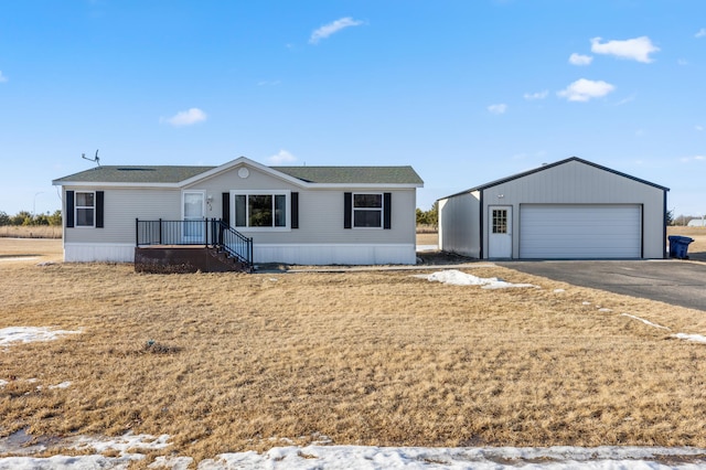 view of front of house featuring a garage and an outdoor structure