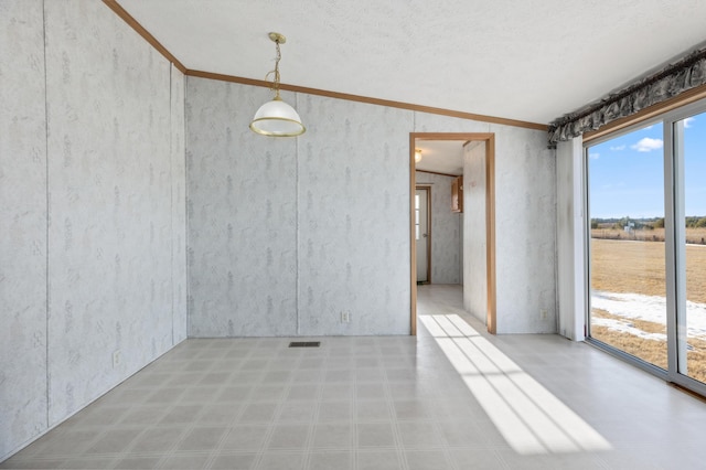 empty room with visible vents, crown molding, and tile patterned floors