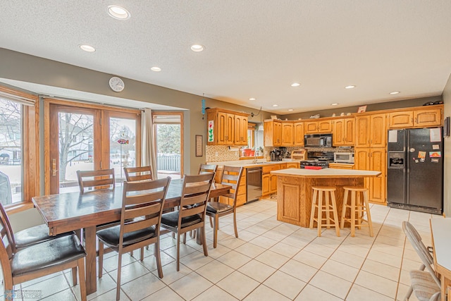 dining area with recessed lighting, a textured ceiling, and light tile patterned flooring