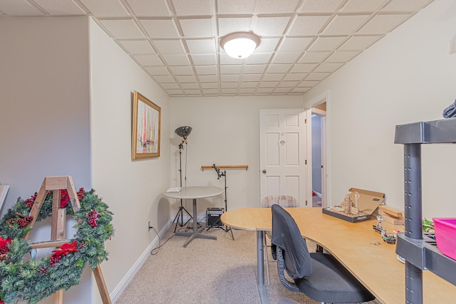 carpeted office space featuring baseboards