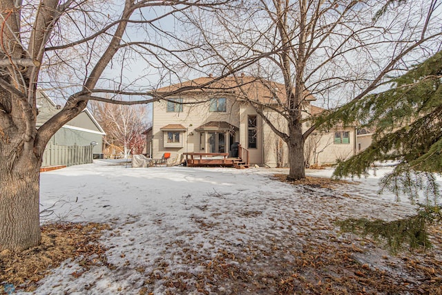 view of front of home featuring fence and a deck