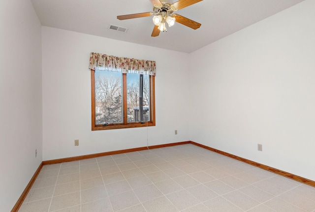 unfurnished room featuring visible vents, ceiling fan, and baseboards