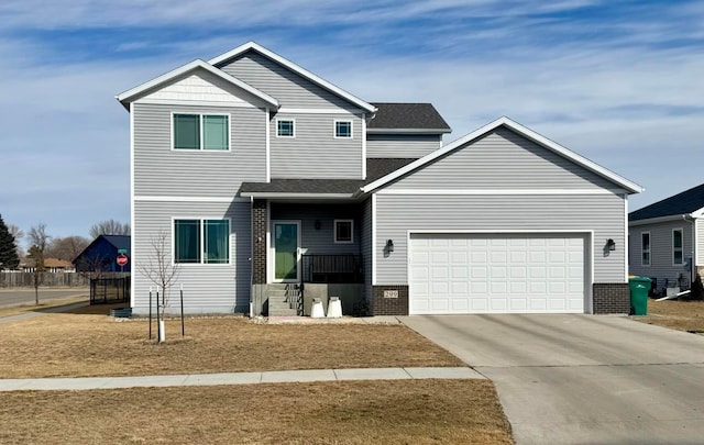 craftsman-style home with a garage, brick siding, and driveway