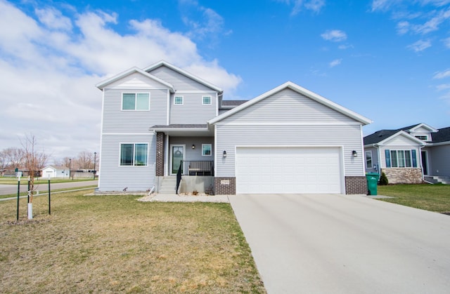 view of front of home with a front lawn, driveway, an attached garage, and brick siding