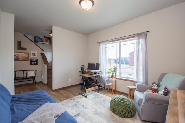 home office with baseboards and wood finished floors
