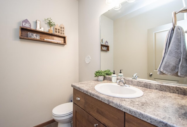 bathroom with toilet and vanity