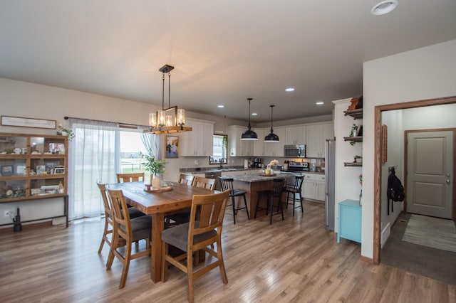 dining space featuring recessed lighting, a notable chandelier, and light wood-type flooring