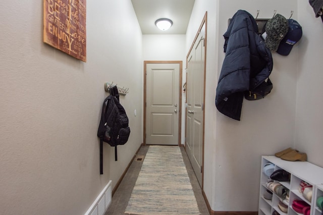 corridor with visible vents and wood finished floors