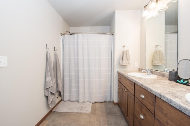 bathroom featuring double vanity, a shower with curtain, and a sink