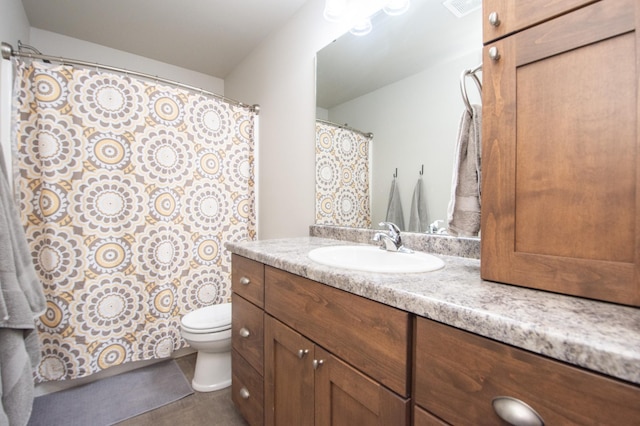 bathroom featuring visible vents, toilet, and vanity