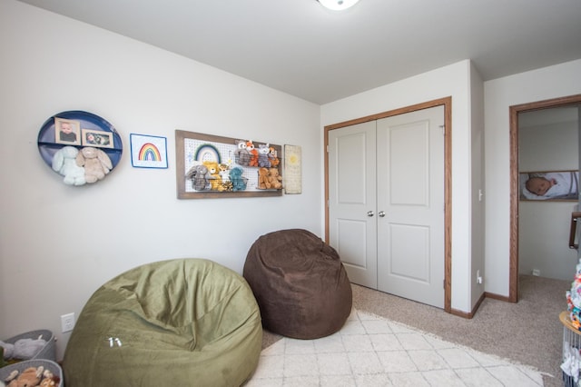 living area with light colored carpet and baseboards