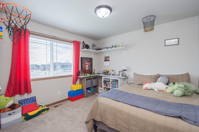 carpeted bedroom featuring visible vents and baseboards