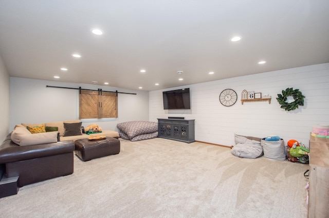 carpeted living room featuring a barn door and recessed lighting