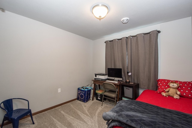 bedroom with carpet flooring and baseboards